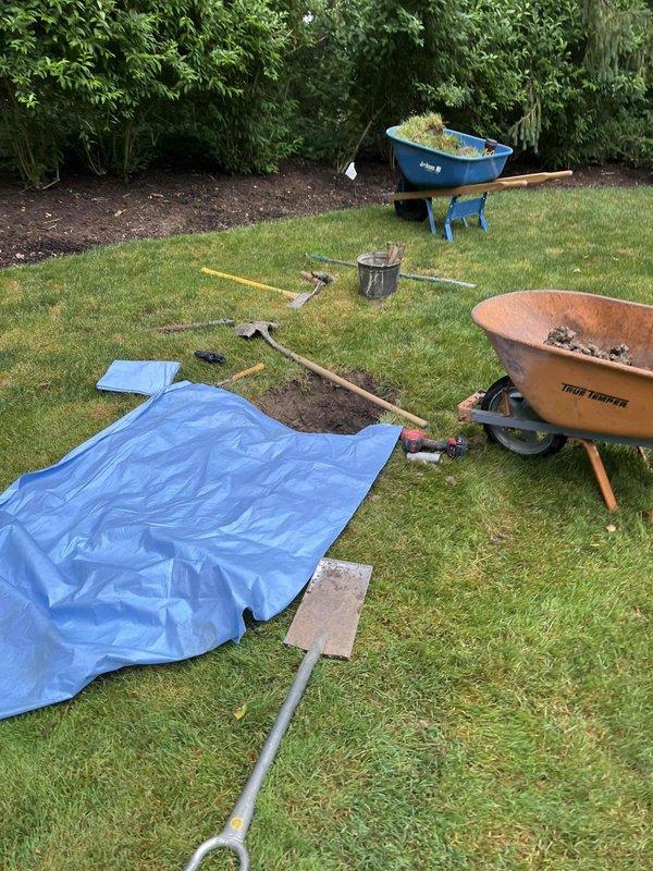 Responded to emergency call for burst copper water line servicing a commercial irrigation system at a landscaping business property. Located and assessed the failed copper pipe section, which was part of a specialized irrigation configuration rather than a standard residential sprinkler system. Shut off water supply to stop active leak and prevent further water damage to the lawn area. Excavated affected section to expose the damaged copper line, removed the compromised pipe segment, and installed replacement copper piping with proper fittings and connections. Pressure tested the repaired line to ensure system integrity and verify no additional leaks were present. Backfilled excavation area and restored work site, leaving landscaping tools and materials staged for property owner's ongoing maintenance operations.