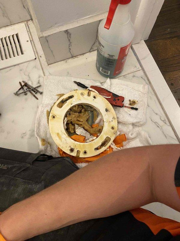 Responded to water leak located beneath bathroom floor. Upon inspection, identified failed toilet flange with significant corrosion and deterioration causing water seepage into subfloor area. Removed damaged flange assembly, cleaned surrounding area, and assessed crawl space below for water damage to floor joists and plumbing infrastructure. Installed replacement flange, secured with new hardware, and verified proper seal to prevent future leaks.