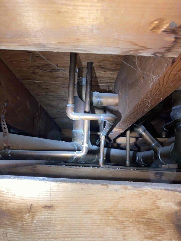 Responded to water leak located beneath bathroom floor. Upon inspection, identified failed toilet flange with significant corrosion and deterioration causing water seepage into subfloor area. Removed damaged flange assembly, cleaned surrounding area, and assessed crawl space below for water damage to floor joists and plumbing infrastructure. Installed replacement flange, secured with new hardware, and verified proper seal to prevent future leaks.
