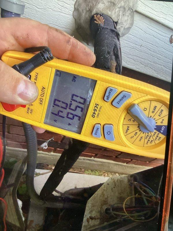 Completed cooling maintenance club visit for member. Performed comprehensive electrical diagnostics on HVAC system using digital multimeter, measuring voltage and amperage readings at both the indoor control panel and outdoor unit electrical connections. All electrical parameters tested within manufacturer specifications, with readings of 85.0V, 12.2V, and 65.5V recorded at various test points. Inspected wiring connections at exterior wall penetration point and noted minor wear on conductor insulation. System operating normally with no deficiencies requiring immediate attention.
