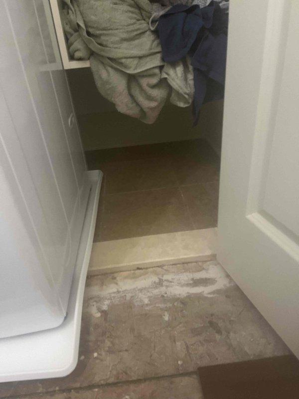 Replaced faulty washing machine shut-off valve in laundry room utility area. The original valve was incorrectly installed and required removal and replacement with proper chrome lever-handle shut-off valve to restore safe water supply connection to the washing machine.