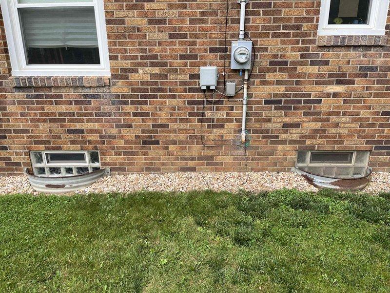 Responded to service call for small leak at bottom of tanked water heater in 70-year-old residential property. Upon inspection, identified moisture accumulation at base of Rheem water heater unit located in basement utility area. Assessed all visible plumbing connections, including copper supply lines and discharge piping, for signs of active leakage or corrosion. Examined temperature and pressure relief valve, drain valve, and tank integrity. Documented existing conditions including concrete floor staining consistent with previous moisture exposure. Photographed water heater installation, surrounding plumbing infrastructure, and exterior foundation areas including basement window wells for comprehensive service records.
