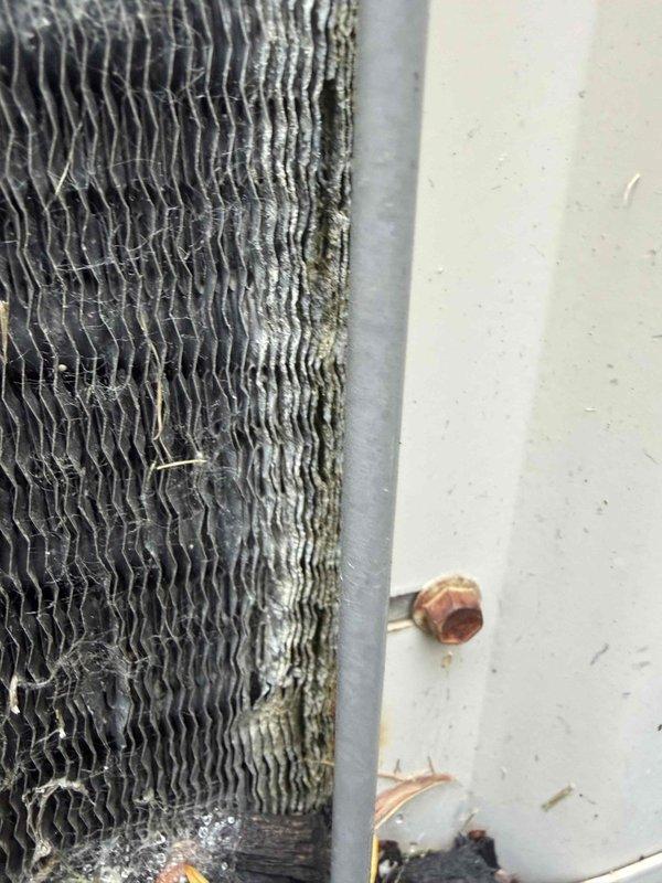 Responded to no cooling complaint with unit blowing lukewarm air. Upon arrival, inspected residential HVAC system and found evaporator coil with dust and debris accumulation affecting heat transfer efficiency. Examined refrigerant connections and confirmed no visible ice formation on unit at time of inspection. Verified thermostat operation and system response. Cleaned evaporator coil fins to restore proper airflow and heat exchange capacity. Checked refrigerant line connections and service ports for proper operation. System restored to normal cooling function with improved air temperature output.