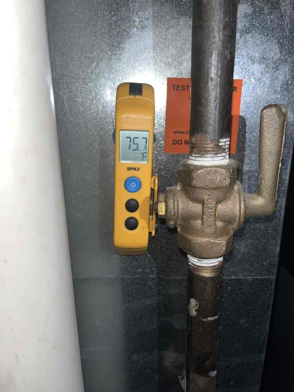 Performed warranty diagnostic evaluation on HVAC system. Used digital thermometer to measure supply and return air temperatures, recording readings of 75°F at the main plenum and 59°F at the evaporator coil outlet. Documented system operating conditions and component temperatures with photographic evidence for warranty claim processing.