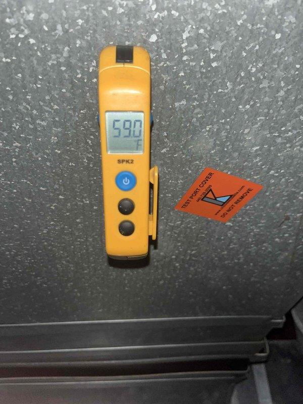 Performed warranty diagnostic evaluation on HVAC system. Used digital thermometer to measure supply and return air temperatures, recording readings of 75°F at the main plenum and 59°F at the evaporator coil outlet. Documented system operating conditions and component temperatures with photographic evidence for warranty claim processing.