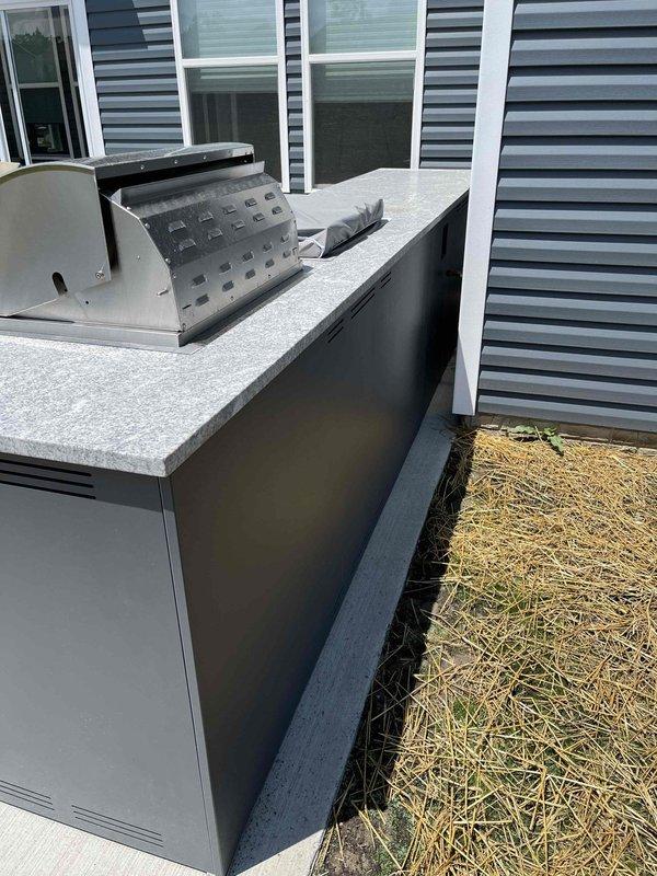 Conducted site assessment for gas line installation to service newly installed outdoor kitchen with dual grill setup. Evaluated existing gas line stub-out in backyard and determined routing requirements to connect two built-in stainless steel grills integrated into permanent cabinetry structure. Inspected grill cabinet interior access points and confirmed clearances for proper gas piping installation, connection points, and compliance with safety codes for outdoor gas appliance installations.