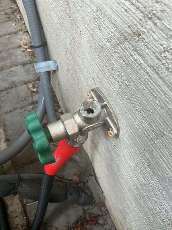 Responded to callback for outdoor hose bibb leaking during operation. Upon inspection, found damaged internal components causing water to spray from valve body when opened. Removed and replaced defective white plastic retention collar and seal assembly. Tested valve operation under full water pressure to verify proper function and confirmed no leaks present.