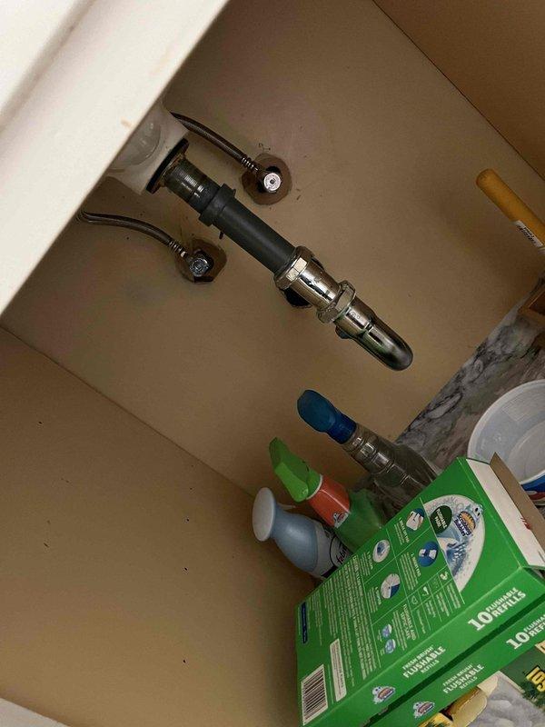 Responded to service call for slow-draining bathroom fixtures in a residential property over 50 years old. Upon arrival, accessed plumbing system through wall-mounted access panel to inspect aging copper supply line configuration. Examined under-sink cabinet area and plumbing connections for blockages and drainage issues. Utilized handheld electronic diagnostic equipment to assess drain flow and identify obstruction points within the aging plumbing system. Inspected visible copper piping showing age-related patina and discoloration consistent with original installation. Addressed drainage concerns in bathroom fixtures by clearing accumulated debris and buildup common in older residential plumbing systems. Verified proper water flow restoration and confirmed all drains functioning at normal capacity upon completion.