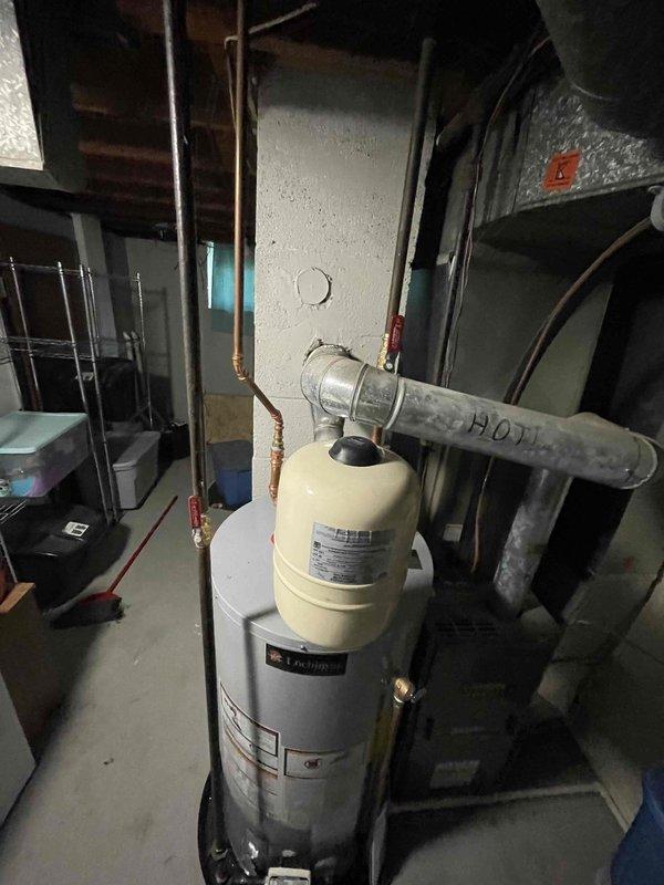 Completed installation of 40-gallon residential water heater as a like-for-like replacement unit in basement utility area. Connected supply and distribution lines including copper piping and PEX connections, installed expansion tank, and verified proper operation of all plumbing connections and hot water distribution system.