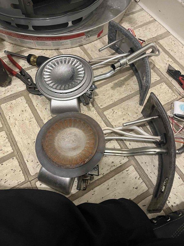 Responded to no hot water complaint at residential apartment building. Upon inspection, diagnosed failed heating element in tanked water heater unit. Removed corroded heating element showing significant rust buildup and deterioration. Installed new replacement heating element and verified proper electrical connections. Tested unit operation and confirmed hot water restoration. Documented existing conditions with photos showing comparison between failed and new components.