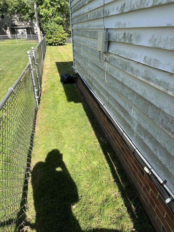 Conducted site assessment for HVAC system replacement at residential property. Evaluated existing aging furnace unit located in basement mechanical room, noting accumulated dust and wear on equipment. Inspected exterior access pathway along side yard for equipment removal and installation logistics. Documented current system configuration including ductwork layout and electrical connections. Provided comprehensive replacement options and equipment recommendations based on home's heating and cooling requirements.