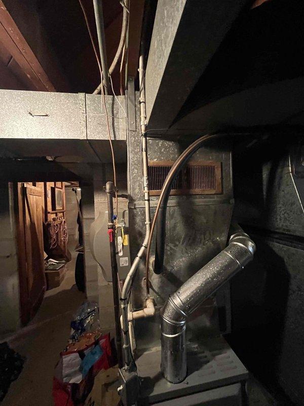 Conducted site assessment for HVAC system replacement at residential property. Evaluated existing aging furnace unit located in basement mechanical room, noting accumulated dust and wear on equipment. Inspected exterior access pathway along side yard for equipment removal and installation logistics. Documented current system configuration including ductwork layout and electrical connections. Provided comprehensive replacement options and equipment recommendations based on home's heating and cooling requirements.