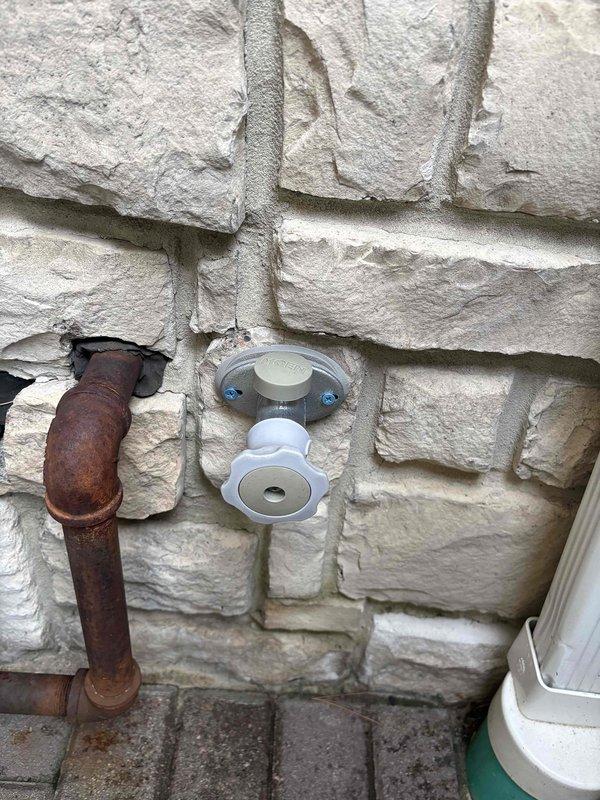 Conducted comprehensive gas line assessment of residential property piping systems. Evaluated exterior gas line infrastructure, identifying severely corroded metal piping requiring replacement due to extensive rust deterioration and compromised structural integrity. Documented newer PVC installations and mounting hardware on exterior stone wall. Inspected interior gas line routing through unfinished space, assessing copper piping runs, support bracket installations, and clearances from electrical systems and HVAC components. Photographed existing conditions of both deteriorated and functional piping for estimate preparation and recommended replacement of compromised exterior gas lines to ensure safe operation and code compliance.