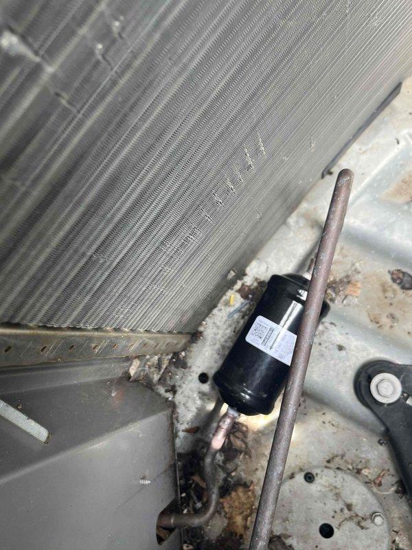 Returned to property to replace evaporator coil under warranty with two-technician crew. Removed existing failed evaporator coil from air handler and installed new replacement unit. Connected refrigerant lines to new coil, installed filter drier, and ensured proper fitment within existing housing. Verified thermostat operation and system functionality upon completion, with unit running and maintaining proper temperature control.