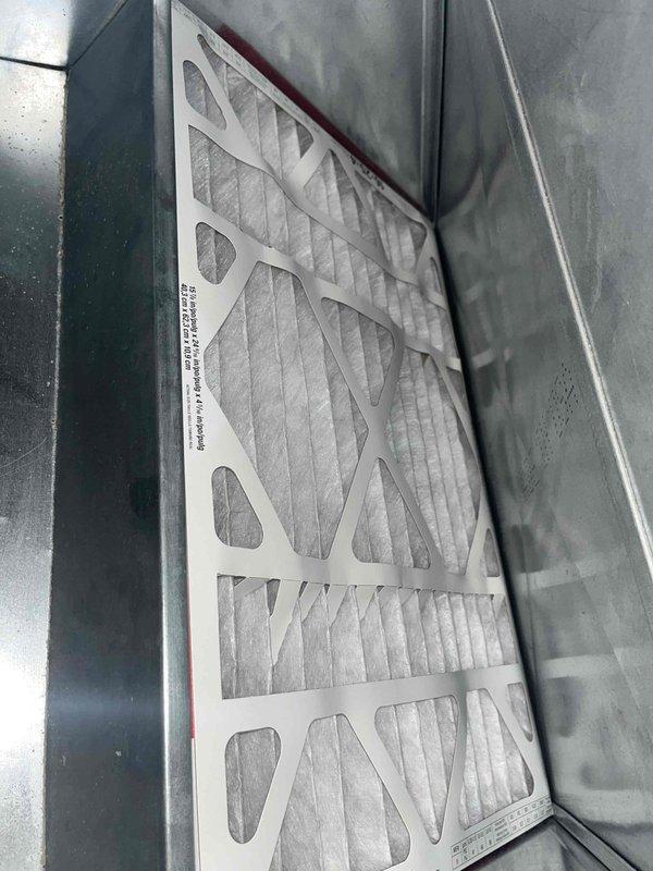Completed routine cooling maintenance inspection for club member. Documented significant dust and lint accumulation on refrigerant line insulation at wall penetration point, and inspected air filter condition within the air handler unit. Filter media appeared functional with normal light dust accumulation, and all accessible HVAC components were photographed for maintenance records.