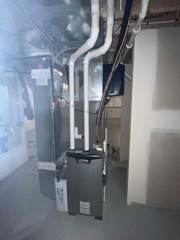 Completed cooling maintenance club visit on residential air handler system. Performed electrical diagnostics using digital multimeter, recording amperage draw of 52.7A on system components to verify proper operation within manufacturer specifications. Conducted comprehensive inspection of HVAC equipment located in basement mechanical room, including furnace unit and associated air handling components. Verified proper installation and routing of PVC condensate drain lines and exhaust venting. All systems operating normally with no deficiencies noted.