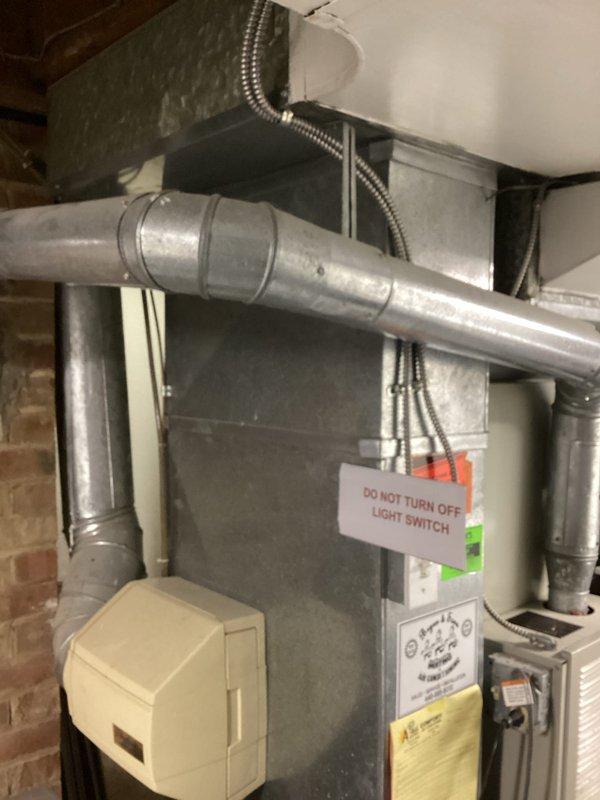 Conducted comprehensive evaluation of aging residential air conditioning system that had not received maintenance in over five years. Inspected outdoor condensing unit, indoor air handler with PVC condensate drainage system, and associated ductwork in basement mechanical room. Assessed system age, operational efficiency, and overall condition to determine viability of continued operation versus replacement. Documented existing equipment configuration including gray metal furnace cabinet, cream-colored air handler unit, silver metallic ductwork, and humidifier installation. Prepared detailed estimate for energy-efficient replacement system to improve cooling performance and reduce operating costs.