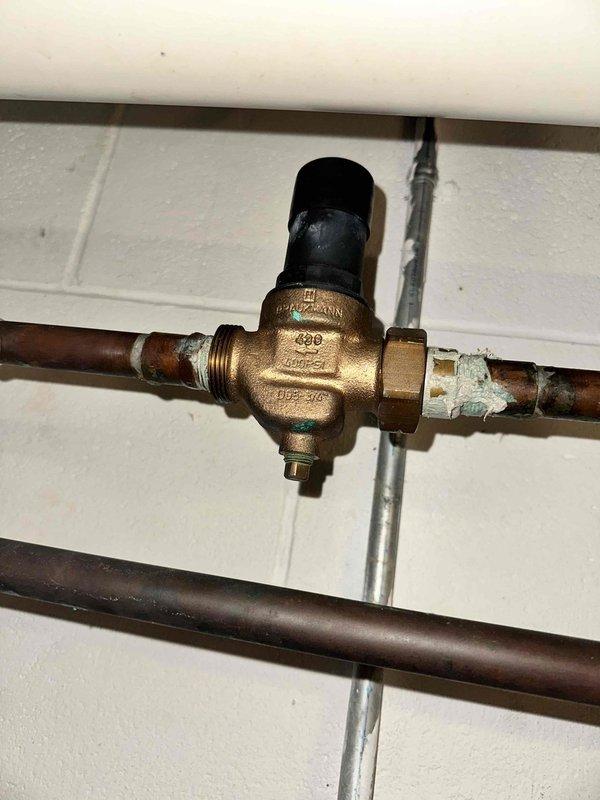 Responded to no-flow condition at newly installed outdoor hose bib. Upon inspection, located shutoff valve in basement that controls outdoor spigot line. Valve was found in closed position, preventing water flow to exterior fixture. Opened isolation valve to restore full water pressure and flow to outdoor bib. Verified proper operation of exterior spigot with no leaks detected at connections or valve body. Customer advised on location of shutoff valve for future seasonal winterization needs.