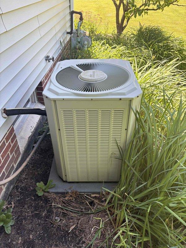Conducted comprehensive HVAC system assessment for complete replacement of 30-year-old furnace and non-operational air conditioning system. Evaluated existing outdoor condenser unit positioned on exterior concrete pad and inspected basement mechanical room containing water heater and associated utility infrastructure to determine optimal equipment specifications and installation requirements for new heating and cooling systems.