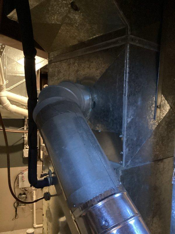 Conducted comprehensive HVAC system evaluation for replacement estimate at residential property. Assessed existing air conditioning system and heating equipment, including furnace with metal plenum ductwork and flexible duct connections in basement mechanical room. Documented current system configuration, operational status, and equipment age through detailed photographs of control panel components and ductwork installation to provide accurate replacement recommendations.