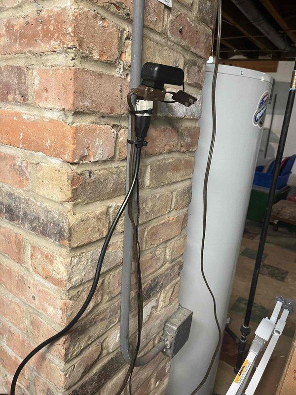 Responded to callback for recurring water leak from furnace. Upon arrival, inspected high-efficiency gas furnace unit and associated condensate drainage system including multiple PVC drain lines. Verified condensate pump operation and checked for blockages in drain lines and trap assembly. Bucket positioned at furnace base indicated active leak mitigation. Examined all pipe connections, seals, and drainage pathways to identify source of water intrusion. Documented equipment condition and drainage configuration for service records.
