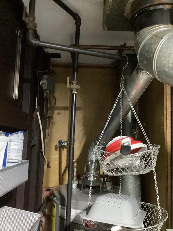 Conducted site assessment for complete HVAC system replacement involving removal of existing aged furnace and installation of new furnace with whole-house air conditioning system where no AC currently exists. Evaluated electrical panel capacity and circuit availability to accommodate new AC unit requirements, photographed existing breaker configuration showing current system loads. Inspected mechanical room layout, ductwork infrastructure, and available space for new equipment installation to develop comprehensive replacement estimate.