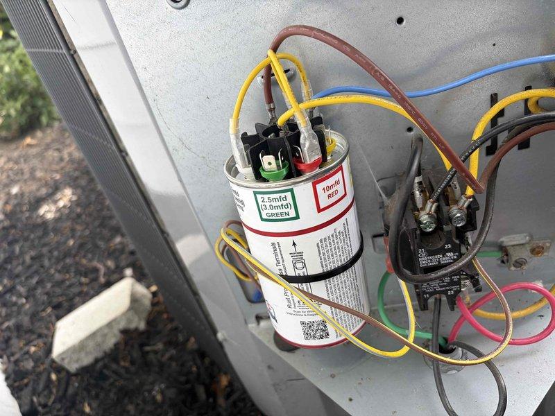 Responded to callback for AC not cooling following previous maintenance. Upon arrival, performed diagnostic testing with digital multimeter to measure operating temperatures and verify system performance. Readings indicated potential issues with electrical components. Inspected condensing unit and found capacitor with specifications of 2.5mfd operating within acceptable parameters. Verified all electrical connections at capacitor terminals and contactor, ensuring proper wire routing and secure terminations per manufacturer specifications. All wiring color codes confirmed correct for compressor and fan motor circuits. System tested and verified operational following inspection.