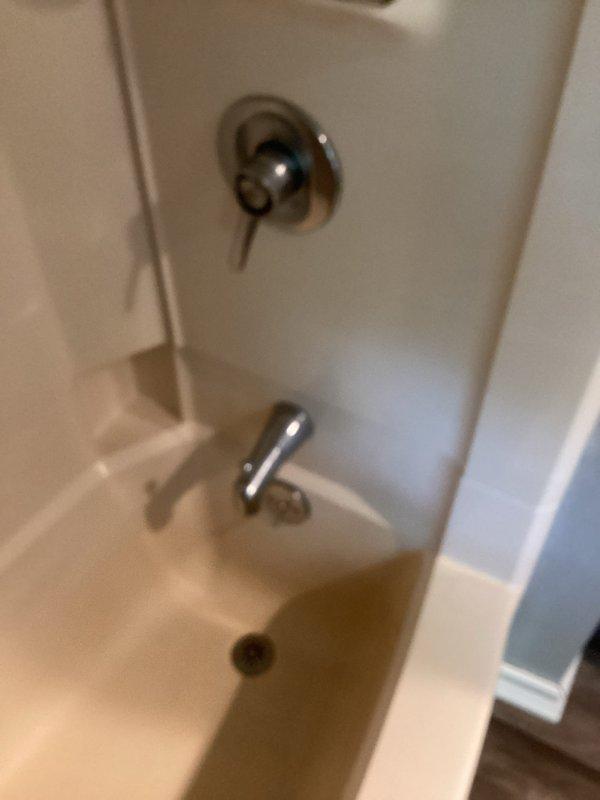 Conducted comprehensive plumbing estimate for water treatment system and related fixtures throughout the property. Assessed outdoor spigot, shower control valve and tub spout in bathroom, water heater installation, and existing water treatment equipment located in basement utility area. Documented current conditions of all plumbing components including chrome-finished bathroom fixtures, galvanized ductwork, and mechanical systems in unfinished basement space to provide accurate recommendations for water treatment solutions and any necessary fixture upgrades or repairs.