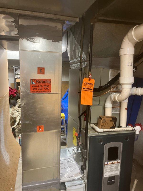 Completed full HVAC system installation in basement mechanical room, including new furnace/air handler unit and associated ductwork. Installed PVC venting system with proper configuration, verified system operation, and confirmed temperature readings at 69.6°F using calibrated digital thermometer. All equipment labeled and secured per manufacturer specifications with proper clearances maintained for service access.