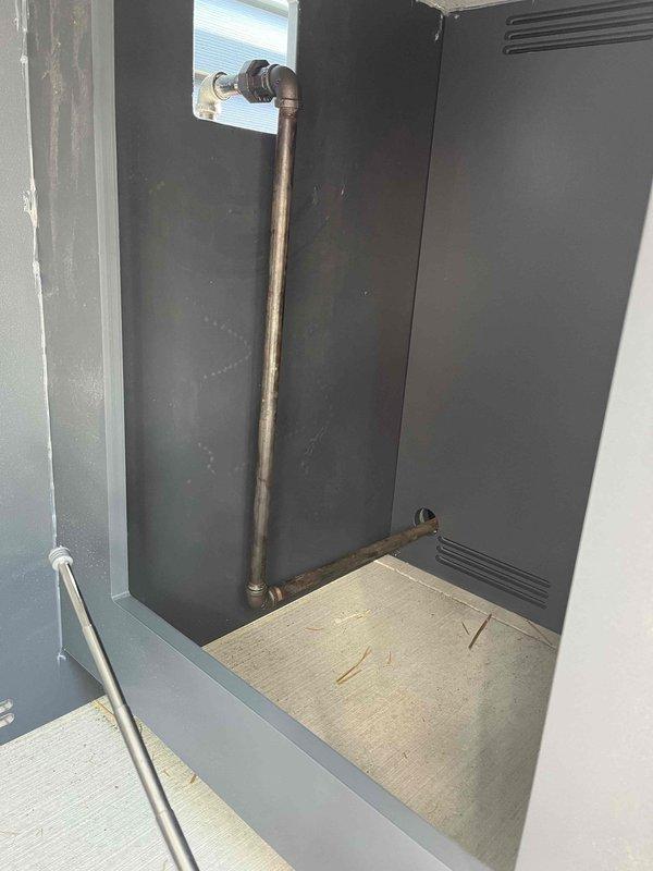 Completed return service for dual gas line installation to outdoor kitchen area. Installed copper gas piping through enclosed cabinet housing with proper 90-degree fittings and vertical-to-horizontal routing. Secured gas line penetrations through equipment enclosure and ensured proper ventilation clearances maintained throughout installation. Routed PVC vent piping through roof access point with appropriate elbow fittings and support brackets along structural framework. All gas connections pressure tested and verified leak-free. Installation meets code requirements for outdoor kitchen gas appliance supply.