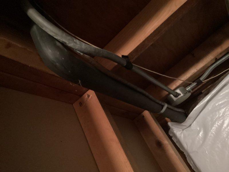 Completed ductwork modifications to accommodate repositioned air handler in attic space. Identified missing air filter bracket requiring installation and noted evaporator coil requires cleaning for optimal system performance. Documented existing flexible ductwork configuration and insulation conditions in confined attic area.