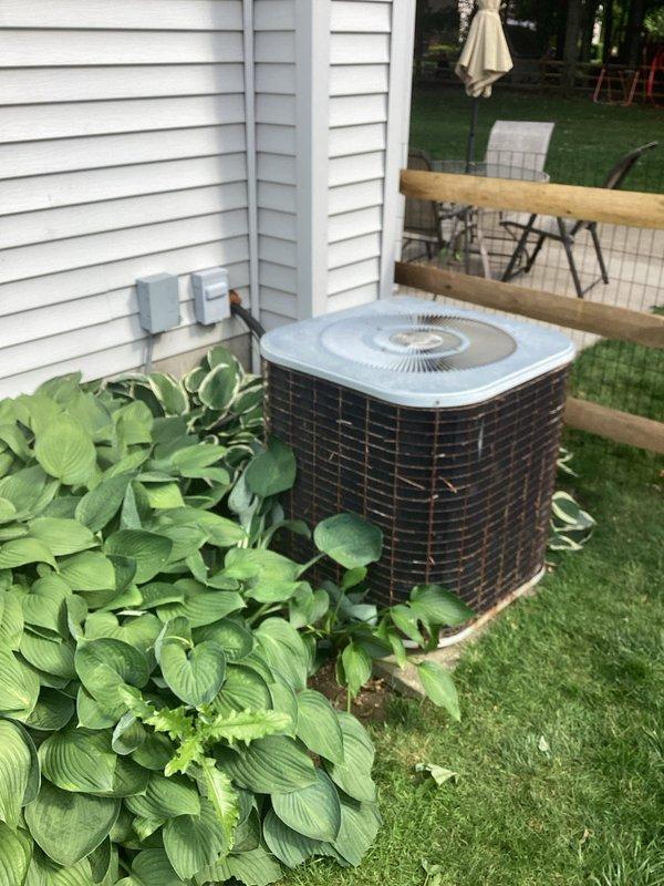 # HVAC Service Report

Responded to no-cool call for residential air conditioning system less than 10 years old. Customer reported outdoor condenser unit not running, thermostat display functioning normally. Upon arrival, located outdoor unit positioned on concrete pad against exterior wall with adequate clearance. Performed visual inspection of condenser unit exterior and surrounding area. Unit appeared properly installed with appropriate electrical disconnect and conduit connections. No visible ice accumulation observed on refrigerant lines or coil surfaces at time of inspection. Verified thermostat was calling for cooling and display was operational as reported. Checked electrical disconnect switch at outdoor unit. Inspected condenser fan motor and compressor for signs of mechanical failure or electrical issues. Documented unit condition and installation environment with photographs for service records. System required further diagnostic testing to determine root cause of outdoor un