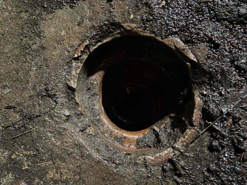 Performed video camera inspection of underground drain system to assess interior pipe condition. Documentation revealed severe corrosion, heavy rust buildup, and mineral deposits throughout the pipeline, with visible deterioration of metal surfaces and compromised structural integrity requiring further evaluation.