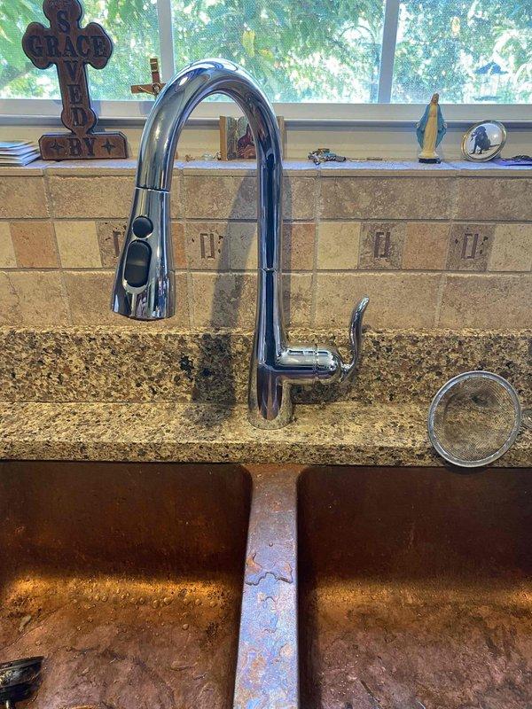 Responded to kitchen sink clog after homeowner attempted chemical drain cleaners without success. Removed and disassembled kitchen faucet with pull-down spray head to access and clear obstruction in drain line. Completed drain cleaning, reassembled faucet assembly, and restored full drainage function to kitchen sink.
