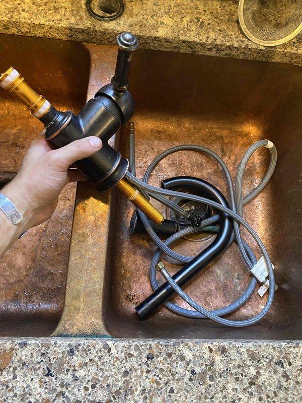Responded to kitchen sink clog after homeowner attempted chemical drain cleaners without success. Removed and disassembled kitchen faucet with pull-down spray head to access and clear obstruction in drain line. Completed drain cleaning, reassembled faucet assembly, and restored full drainage function to kitchen sink.