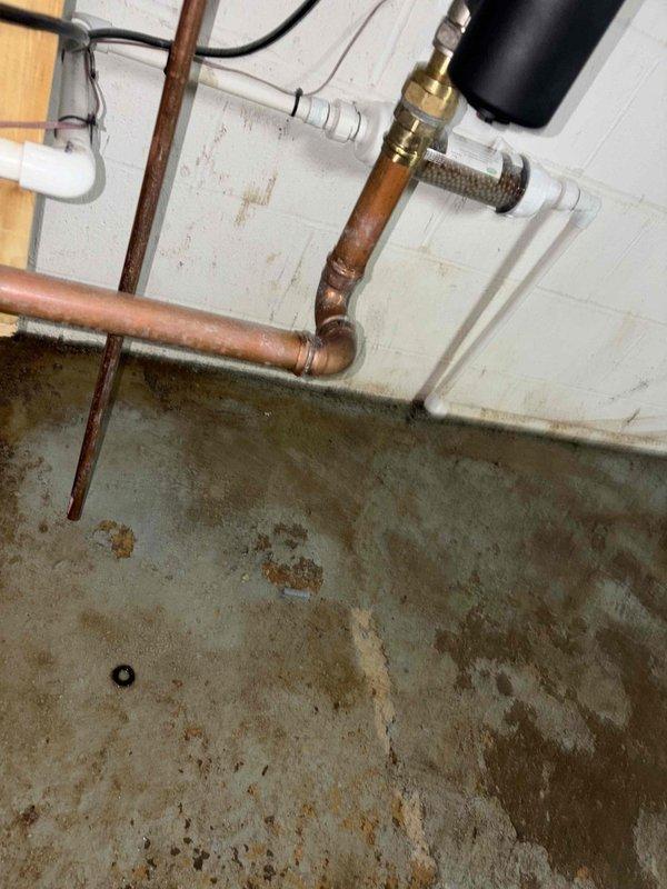 Performed routine maintenance tune-up on boiler system less than one year old. Inspected and addressed reported leak at water filter assembly, which showed signs of moisture at connection points. Examined copper piping, brass fittings, and PVC connections throughout the system, verifying all joints and couplings for proper sealing. Checked filter housing with pressure gauge monitoring device and confirmed all compression fittings were secure. System currently operating within normal parameters with no active leaks detected at time of service completion.