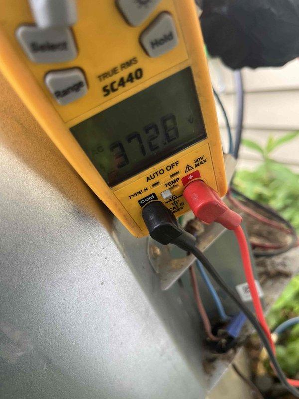 Completed cooling maintenance club visit on air handler system. Performed electrical diagnostics using digital multimeter, recording voltage reading of 37.28V at control circuit. Inspected capacitor, contactors, and control wiring within outdoor unit base, confirming proper electrical connections and component operation. Removed debris and organic matter from unit base. All electrical components functioning within normal parameters, system operational.