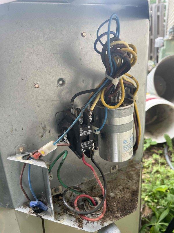 Completed cooling maintenance club visit on air handler system. Performed electrical diagnostics using digital multimeter, recording voltage reading of 37.28V at control circuit. Inspected capacitor, contactors, and control wiring within outdoor unit base, confirming proper electrical connections and component operation. Removed debris and organic matter from unit base. All electrical components functioning within normal parameters, system operational.