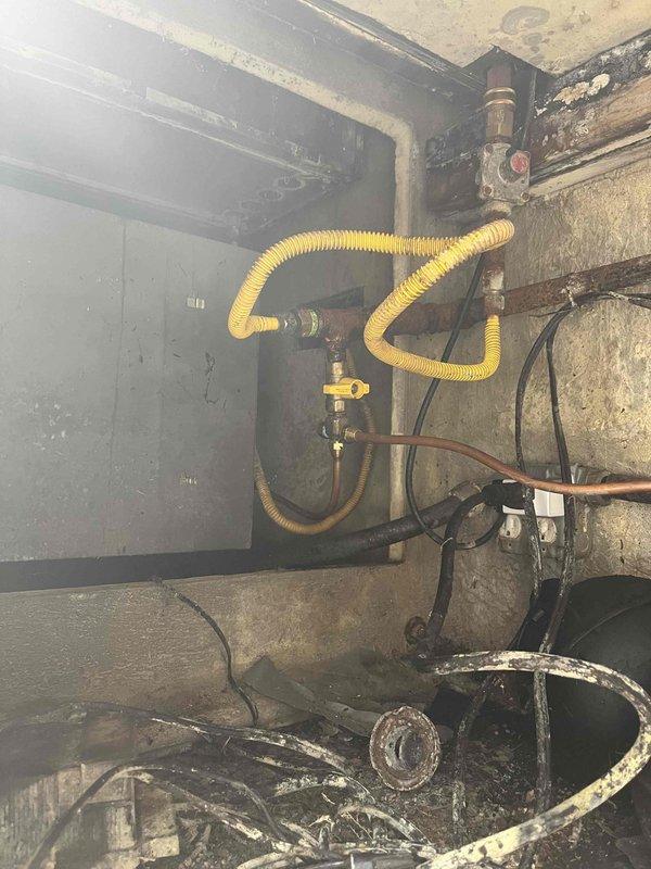 Responded to gas leak at outdoor BBQ grill cabinet and identified undersized gas lines that were improperly exposed. Inspected existing yellow flexible corrugated gas line connections and brass valve assembly in utility area, noting deteriorated conditions and improper installation. Repaired and properly sized gas lines to meet code requirements, ensuring secure connections and adequate gas pressure for safe BBQ operation.