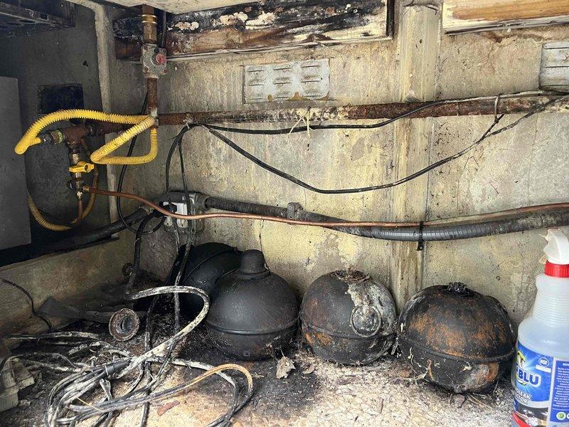 Responded to gas leak at outdoor BBQ grill cabinet and identified undersized gas lines that were improperly exposed. Inspected existing yellow flexible corrugated gas line connections and brass valve assembly in utility area, noting deteriorated conditions and improper installation. Repaired and properly sized gas lines to meet code requirements, ensuring secure connections and adequate gas pressure for safe BBQ operation.