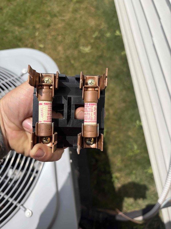 Completed cooling maintenance club visit on air handler system. Performed routine inspection and maintenance procedures per membership agreement. Documented equipment condition including dual-run capacitor (35/5 μF, 440V AC) showing signs of age with surface discoloration and oxidation on casing. Inspected and photographed fuse block assembly with dual copper fuses in working condition. All electrical connections verified secure, system operational at time of departure.
