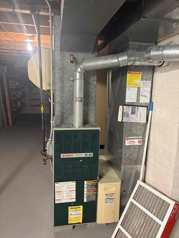 Responded to no cooling call on XL 80 HVAC system. Upon arrival, found system running but not cooling as reported. Inspection revealed two blown fuses in the outdoor condensing unit's disconnect, preventing compressor operation. Replaced failed fuses with proper amperage-rated TRN-R type fuses. Verified thermostat display operational and system power restored. Tested system operation after fuse replacement, confirmed compressor startup and proper cooling cycle initiated. System returned to normal cooling operation.