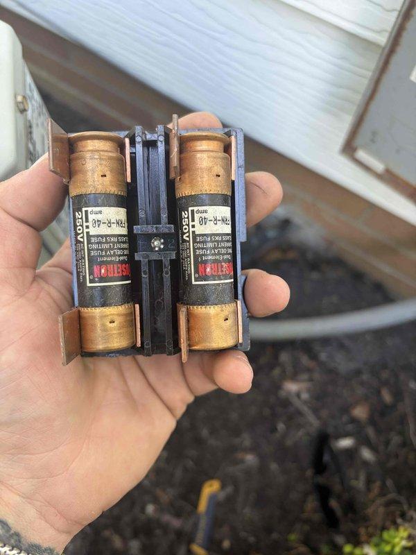 Responded to no cooling call on XL 80 HVAC system. Upon arrival, found system running but not cooling as reported. Inspection revealed two blown fuses in the outdoor condensing unit's disconnect, preventing compressor operation. Replaced failed fuses with proper amperage-rated TRN-R type fuses. Verified thermostat display operational and system power restored. Tested system operation after fuse replacement, confirmed compressor startup and proper cooling cycle initiated. System returned to normal cooling operation.