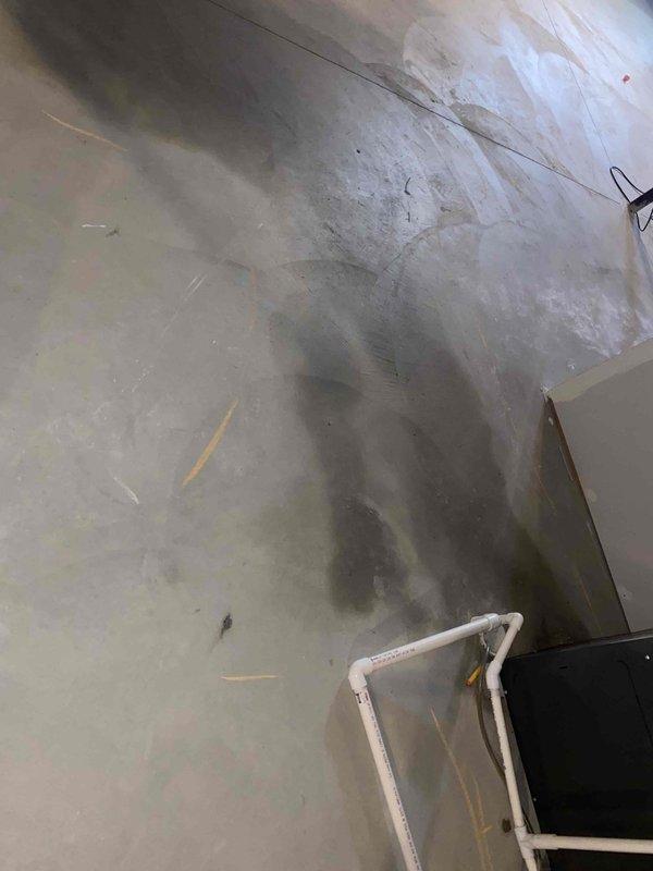 Responded to emergency call for sewage leak in basement of two-year-old home. Upon inspection, identified active sewage discharge on concrete floor near drainage system with visible water damage and staining. Assessed PVC drainage piping configuration along foundation wall, documented conditions with photographs showing horizontal drain lines with multiple fittings and vertical stack connections. Determined source of leak, performed necessary repairs to restore proper drainage function, and verified system integrity to prevent further sewage infiltration into living space.