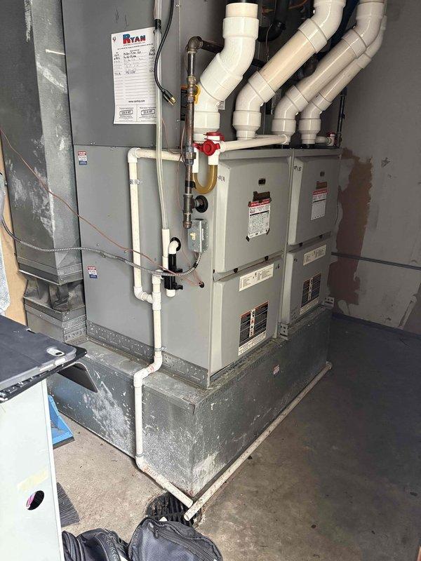 Conducted comprehensive site evaluation for HVAC system replacement on existing residential installation. Assessed current furnace/air handler unit located in basement utility area, documented existing configuration including PVC vent piping, electrical connections, and control board condition. Inspected electronic control board showing multiple circuit connections and functional components, photographed equipment specifications and manufacturer data plates for proper sizing and replacement recommendations. Customer has multiple HVAC units on property and requested estimate specifically for replacement of this single system.