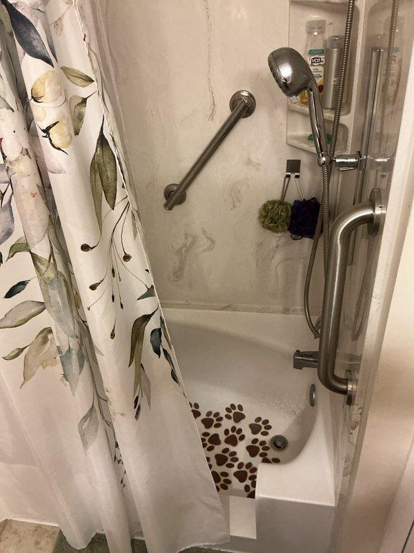 Completed routine plumbing maintenance inspection as part of recurring membership service. Inspected under-sink plumbing connections, drain trap assembly, and supply lines in kitchen area, confirming proper operation and no visible leaks. Evaluated bathroom shower fixtures including dual showerhead system, handheld spray unit, mounting hardware, and safety grab bar installation for proper function and secure mounting.