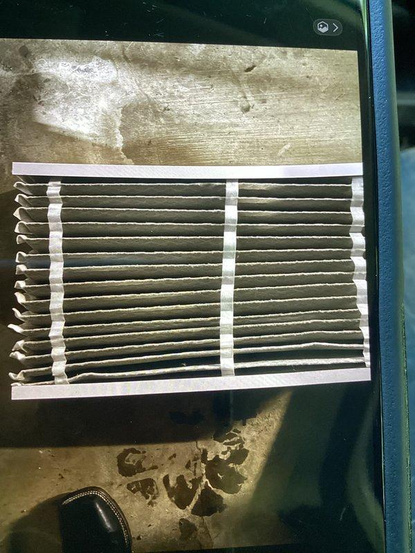 Completed promotional AC tune-up maintenance visit including system inspection and performance verification. Removed and inspected air filter, measured operating amperage at 6.2A and voltage at 0.3V AC using digital multimeter to confirm proper electrical function of system components.