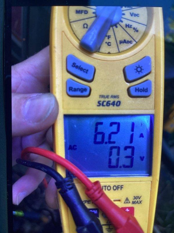 Completed promotional AC tune-up maintenance visit including system inspection and performance verification. Removed and inspected air filter, measured operating amperage at 6.2A and voltage at 0.3V AC using digital multimeter to confirm proper electrical function of system components.