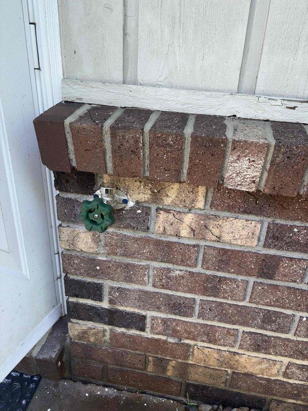 Responded to outdoor water spigot leak on east side of duplex caused by frozen hose attachment. Removed and replaced severely corroded hose bib assembly showing extensive oxidation, mineral buildup, and compromised copper piping connections. Installed new frost-proof sillcock with proper valve seat and threading to prevent future freeze damage.