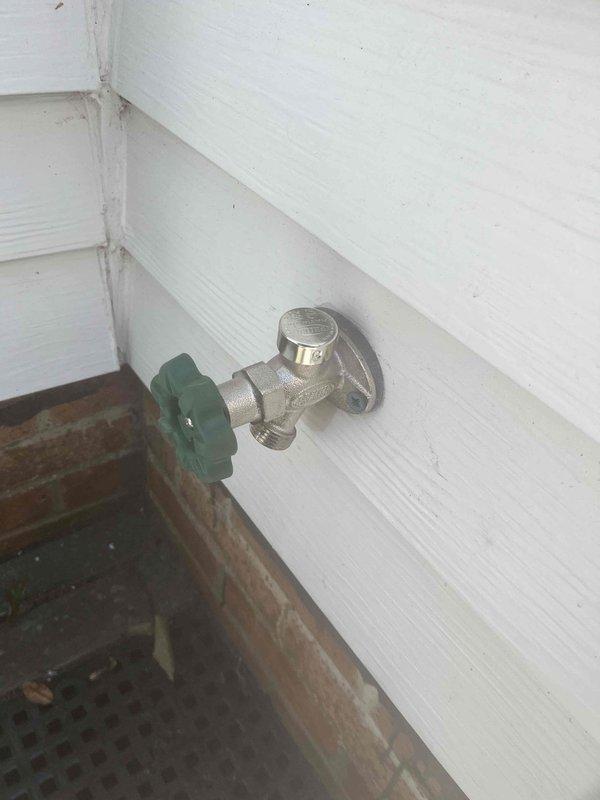 Responded to emergency call for malfunctioning outdoor spigot that would not shut off prior to scheduled home inspection. Successfully replaced failed hose bib valve with new chrome-plated fixture featuring reliable shut-off mechanism and durable green handle control. Verified proper operation and complete water shut-off capability upon completion.